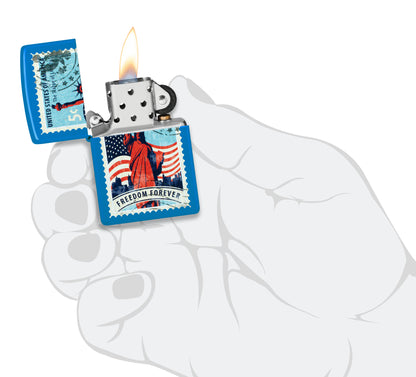 Zippo Stamp of Liberty Design Sky Blue Matte Windproof Lighter lit in hand.