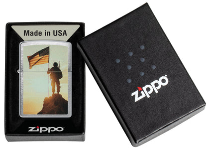 Zippo Soldier and Flag Design Brushed Chrome Windproof Lighter  in its packaging.