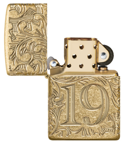 Zippo 1932 Filigree Design  Armor® Tumbled Brass Windproof Lighter with its lid open and unlit.
