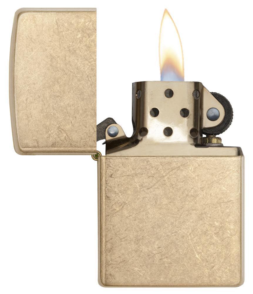 ArmorÂ® Tumbled Brass Windproof Lighter with its lid open and lit