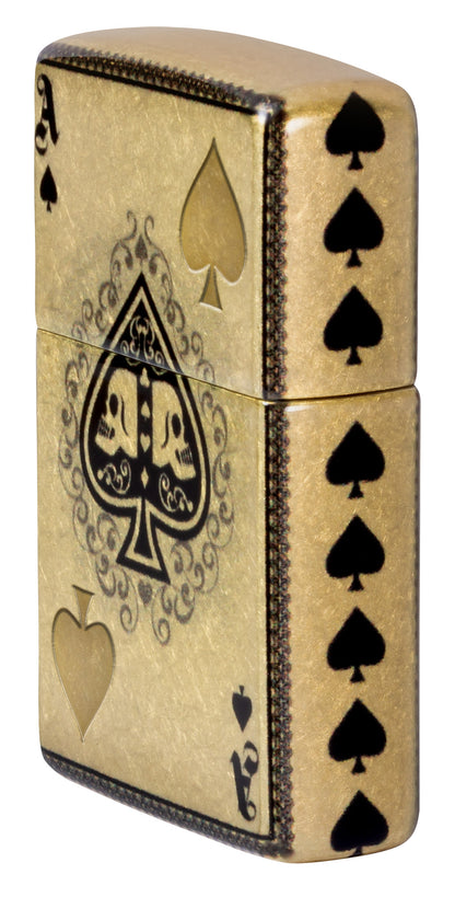Angled shot of Zippo Ace of Skulls Design 540 Tumbled Brass Windproof Lighter showing the front and right side of the lighter.