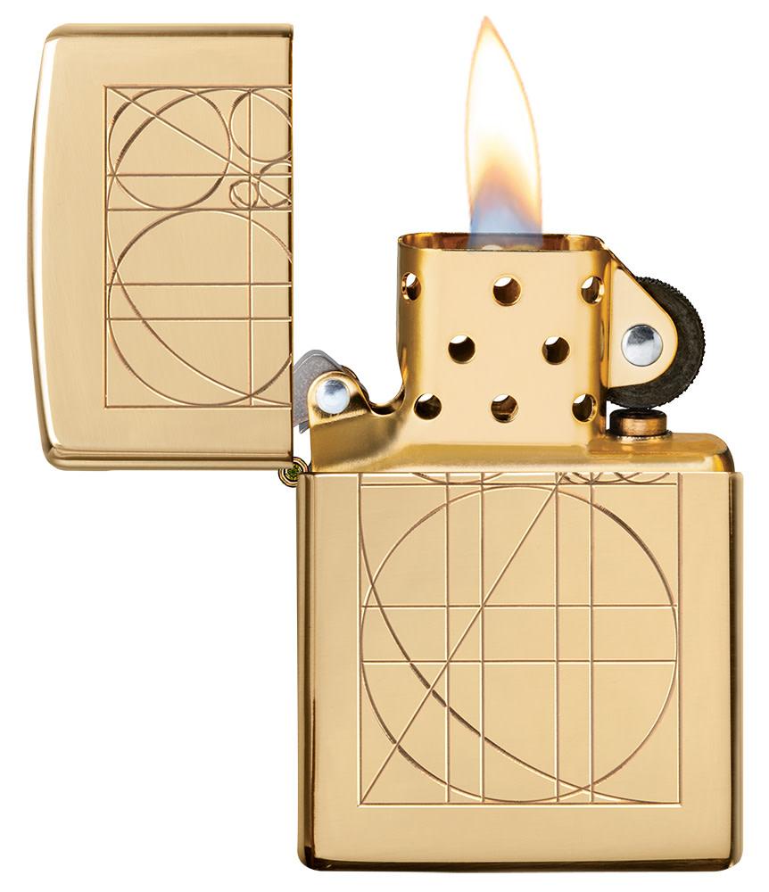 Golden Ratio ArmorÂ® High Polish Brass Windproof Lighter with it lid open and lit