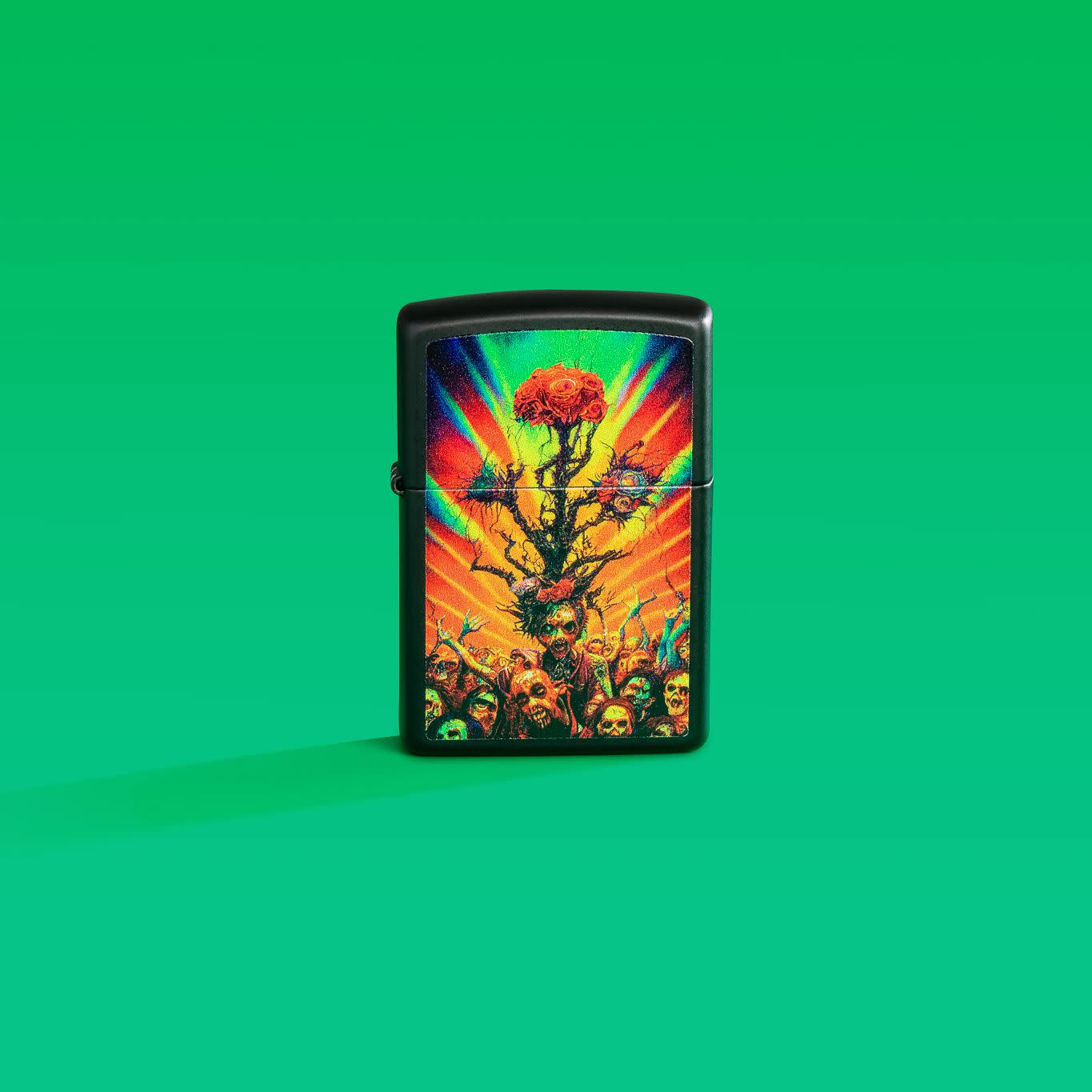 Lifestyle image of Zippo Abstract Zombie Black Matte Windproof Lighter on a green background.