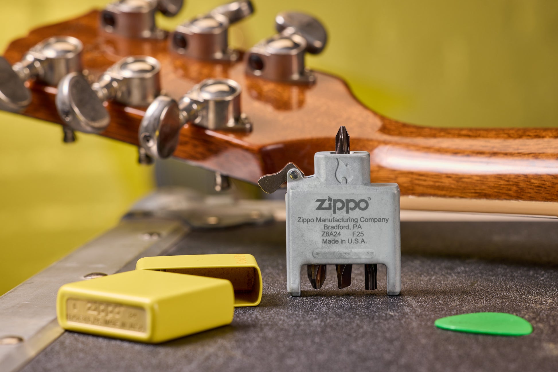 Lifestyle  Image of the Bit Safe Screwdriver USA with Sunflower case both sitting on a table with guitar.